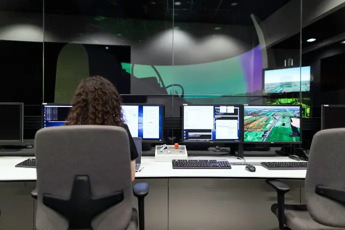 woman sitting on black office rolling chair in front of computer monitor